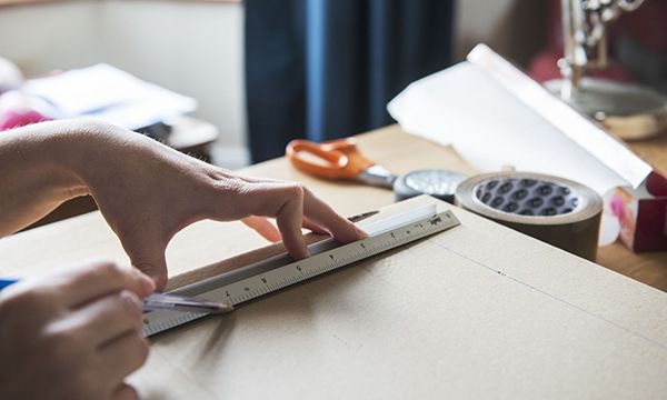 hand drawing renovation plans with ruler