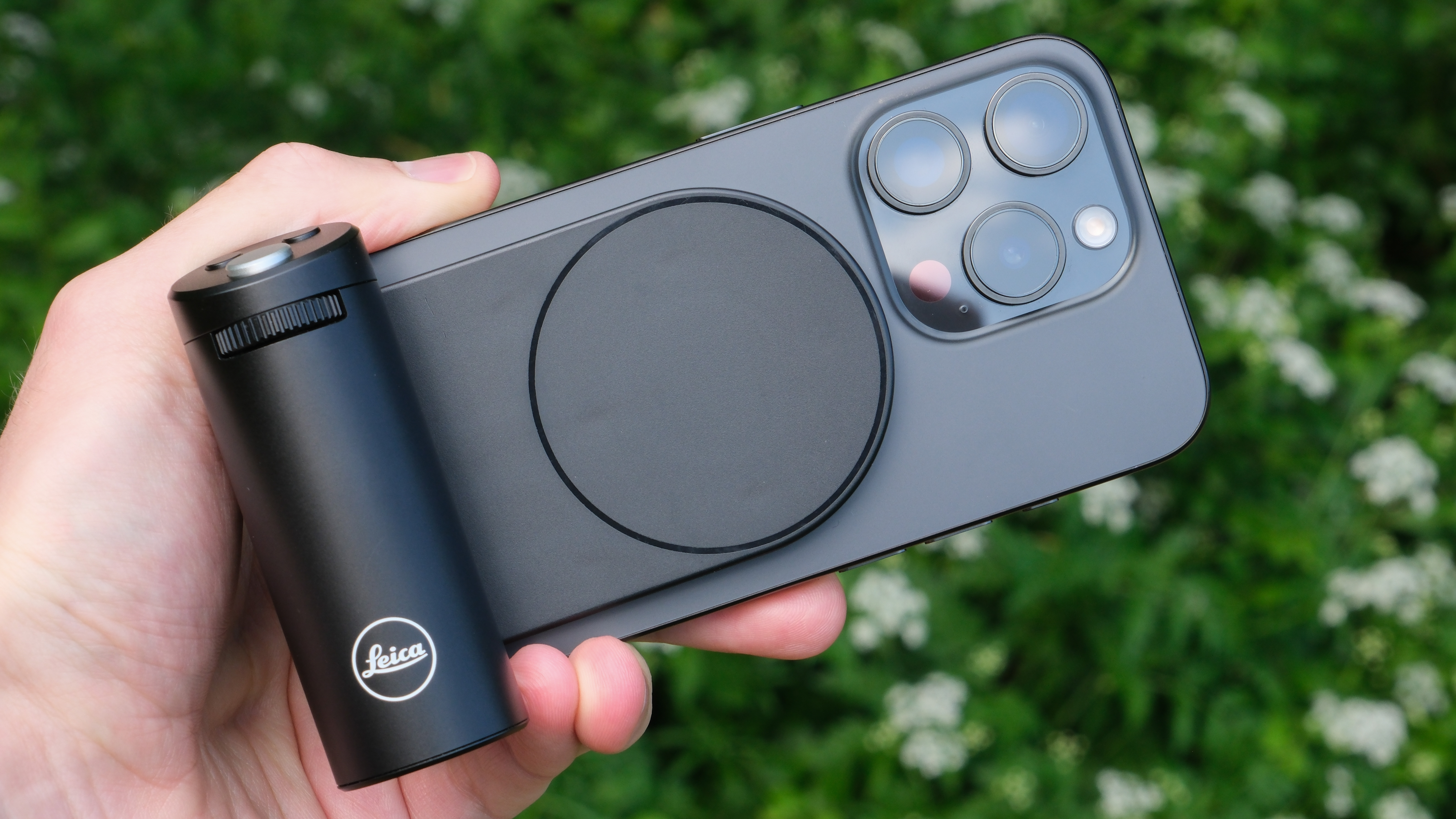 Leica Lux Grip attached to an iPhone and held in a hand