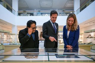 Dutch Prime Minister Mark Rutte looks at 7th century folios from a Quran at the Islamic Arts Museum in 2023