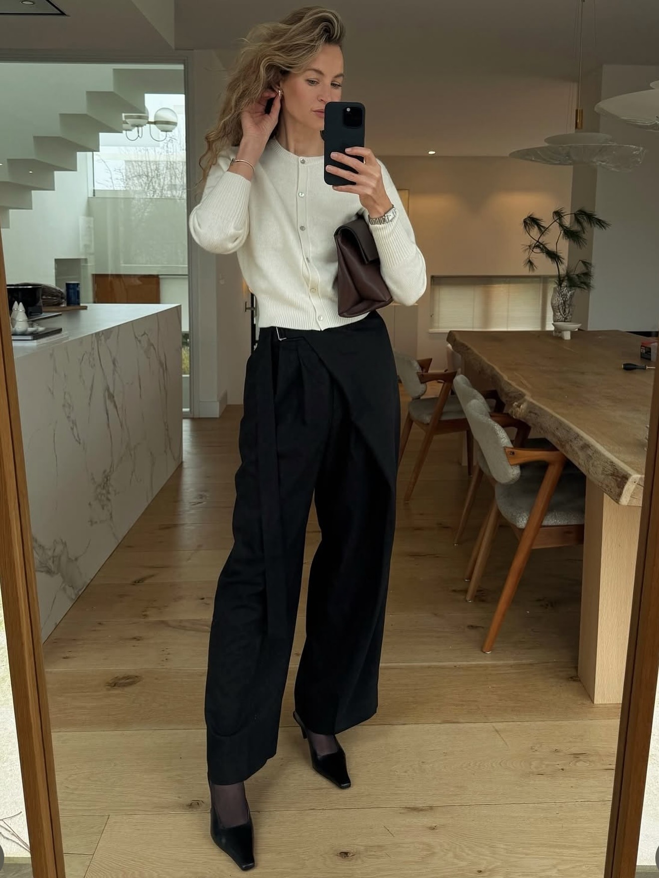 Anouk wears COS wrap front trousers