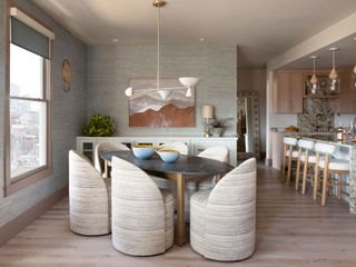 Open-plan kitchen-diner with blue textured wallpaper and beige-pink trim
