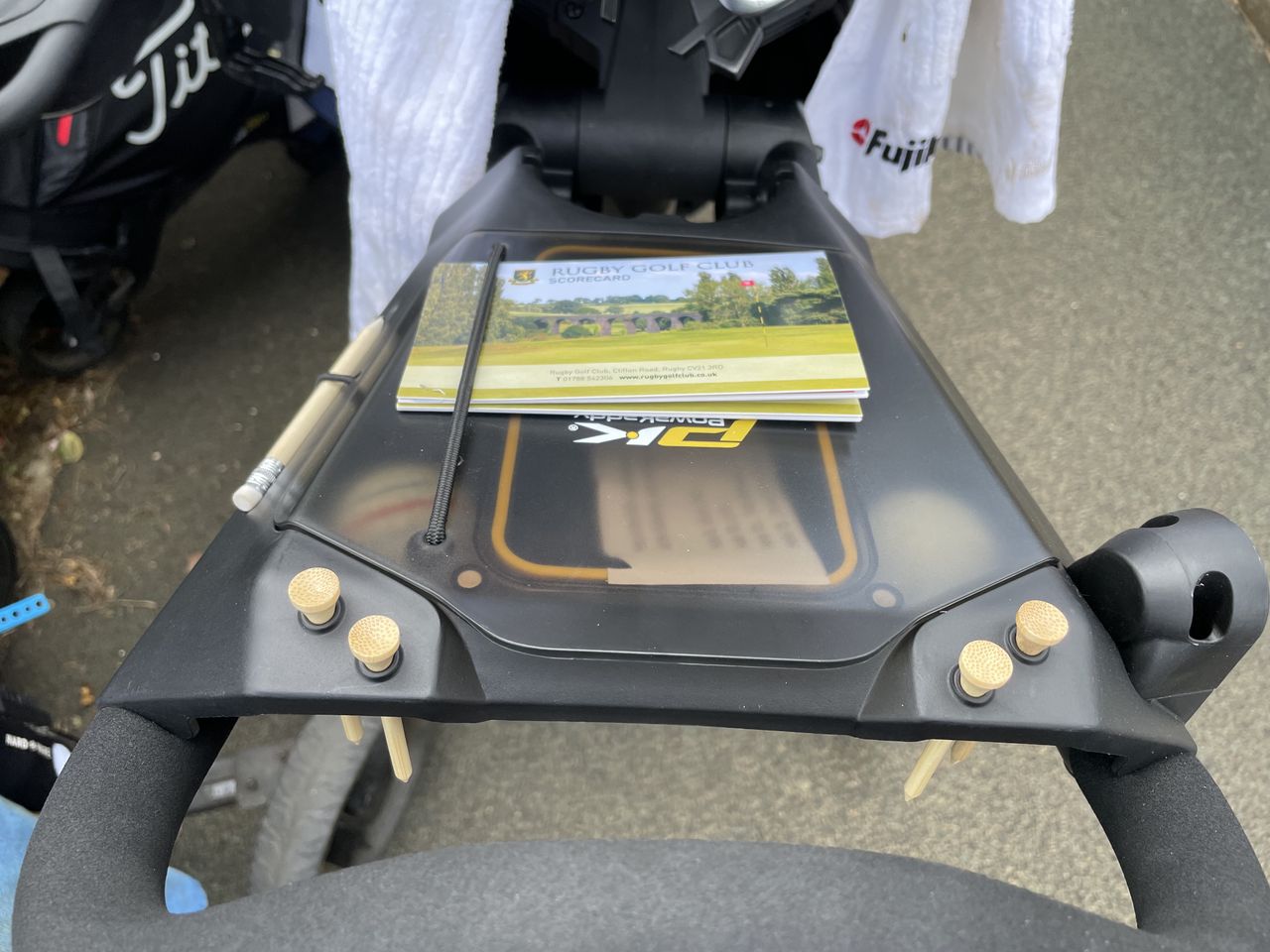 The storage area on the PowaKaddy Micra with the lid closed and a scorecard on top