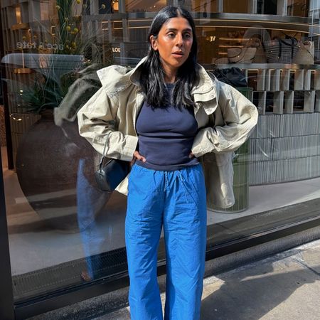 Monikh wears a jacket, navy tee, and blue leset kyoto pants.
