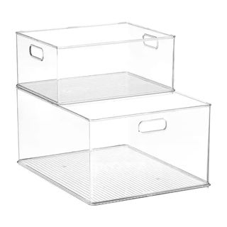 Clear plastic stacking bins on a white background