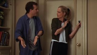 Paul Reiser and Helen Hunt in front of a door