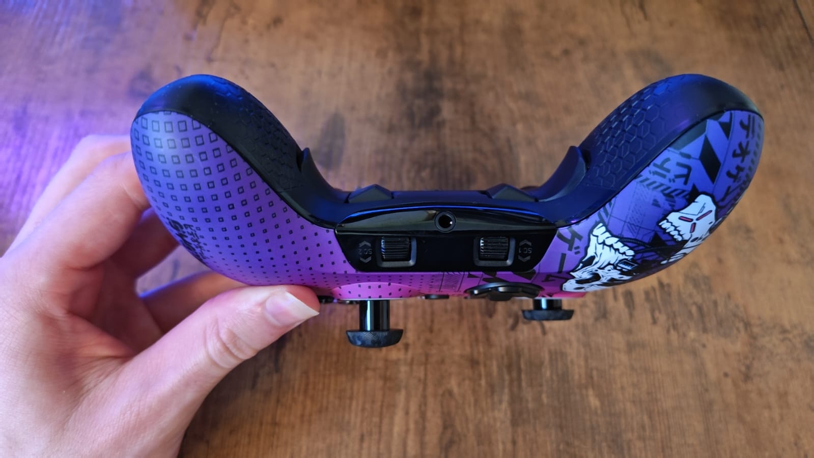 A reviewer showcasing the angle of the Scuf Valor Pro Wireless back buttons