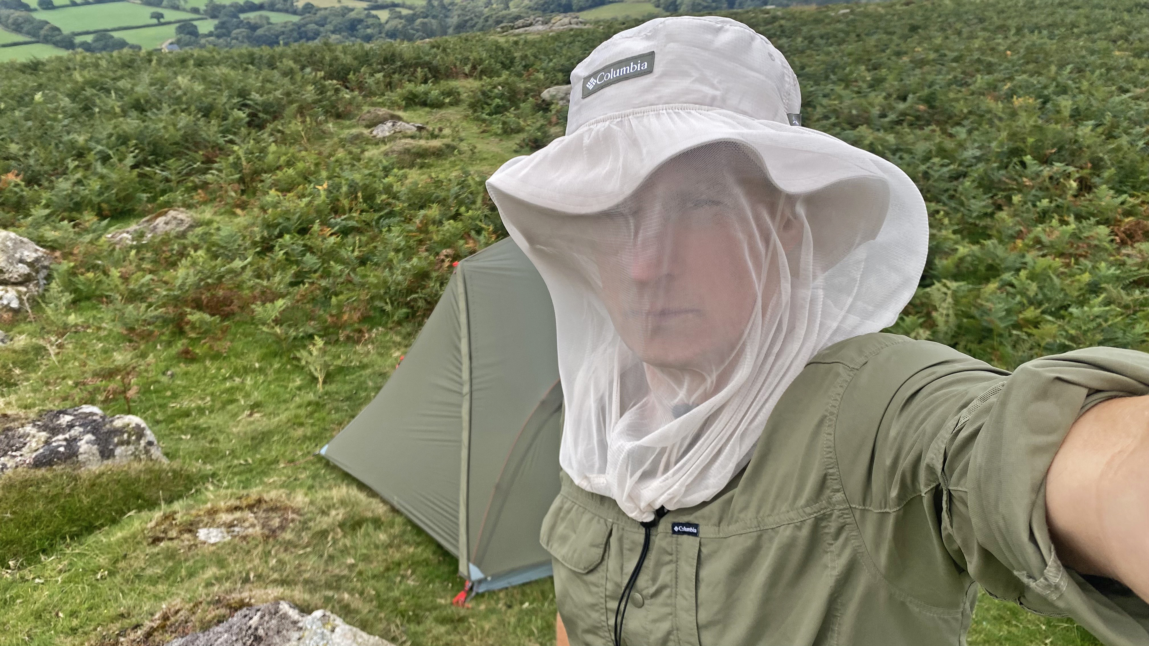 Camper wearing the Columbia Skien Valley Booney Hat with the face net deployed