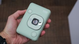 Fujifilm Instax Mini LiPlay camera held in a hand