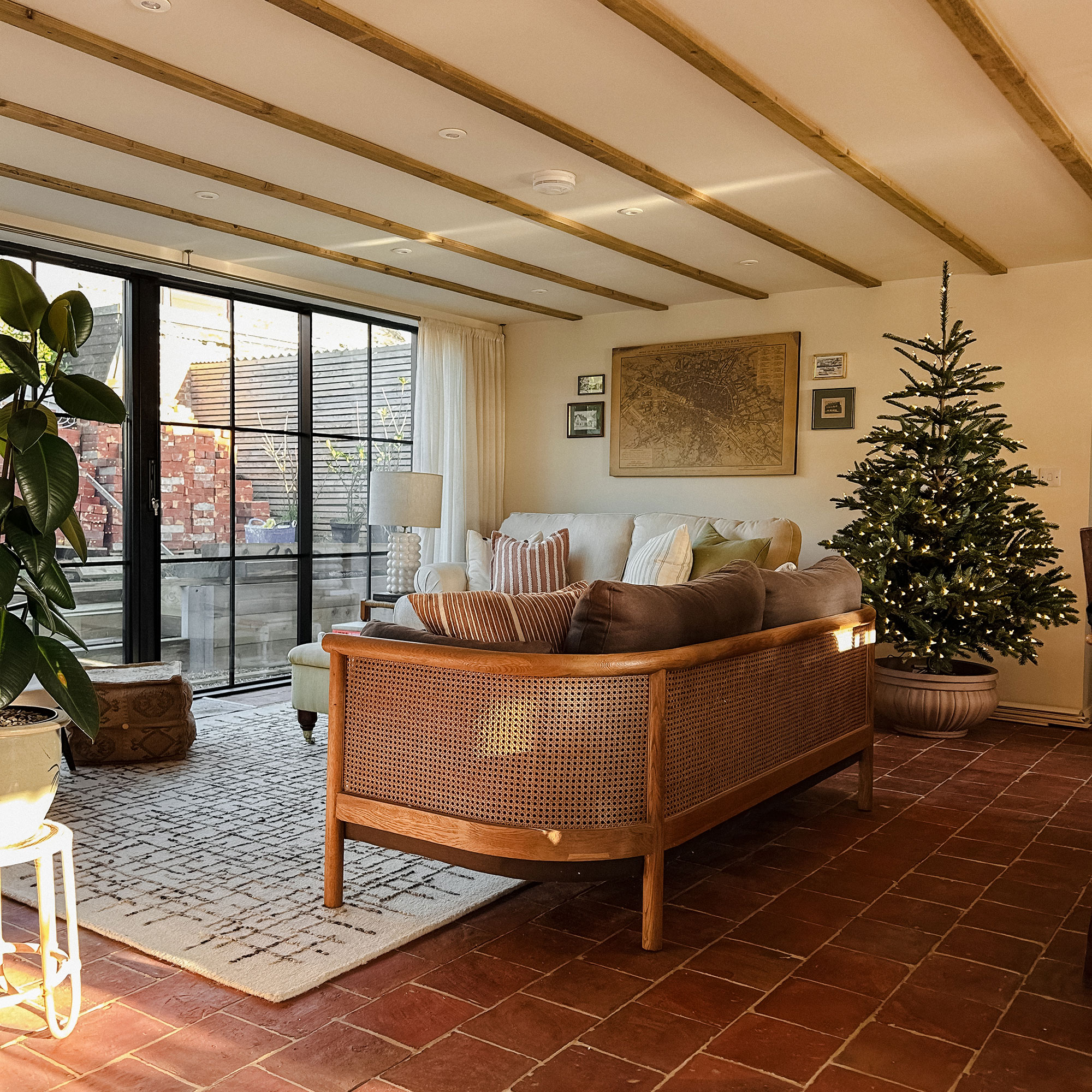 Living room with cane sofa and wooden beams