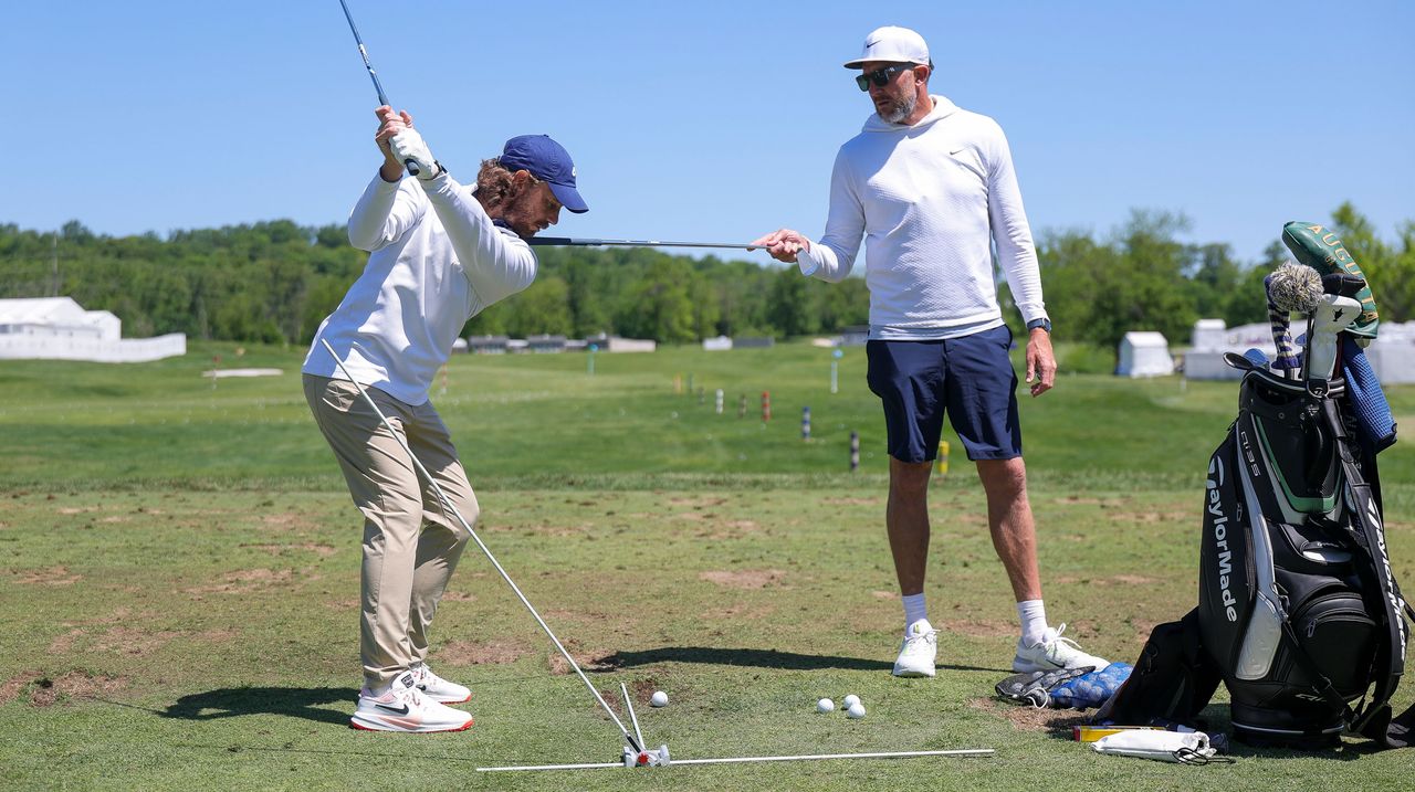 Tommy fleetwood practicing with a swing plane training aid