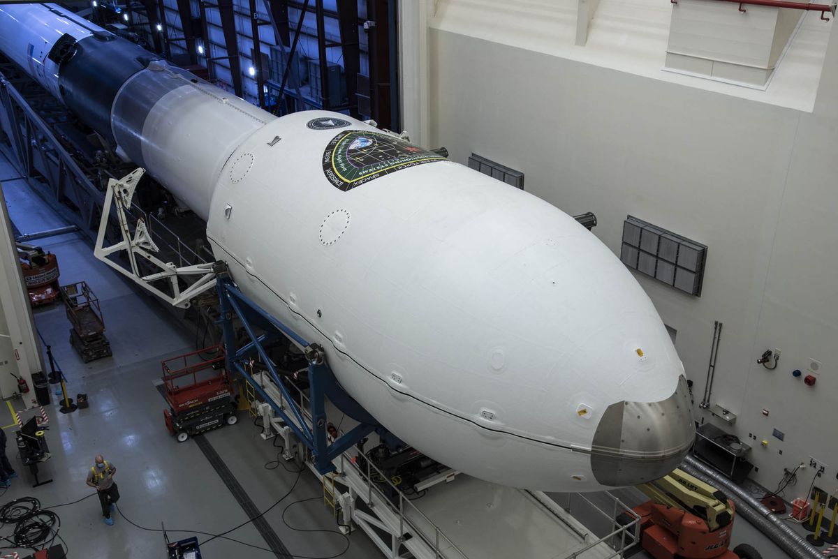 SpaceX workers prepare a new Falcon 9 rocket to launch the advanced GPS III SV03 satellite from Cape Canaveral Air Force Station for the U.S. Space Force.