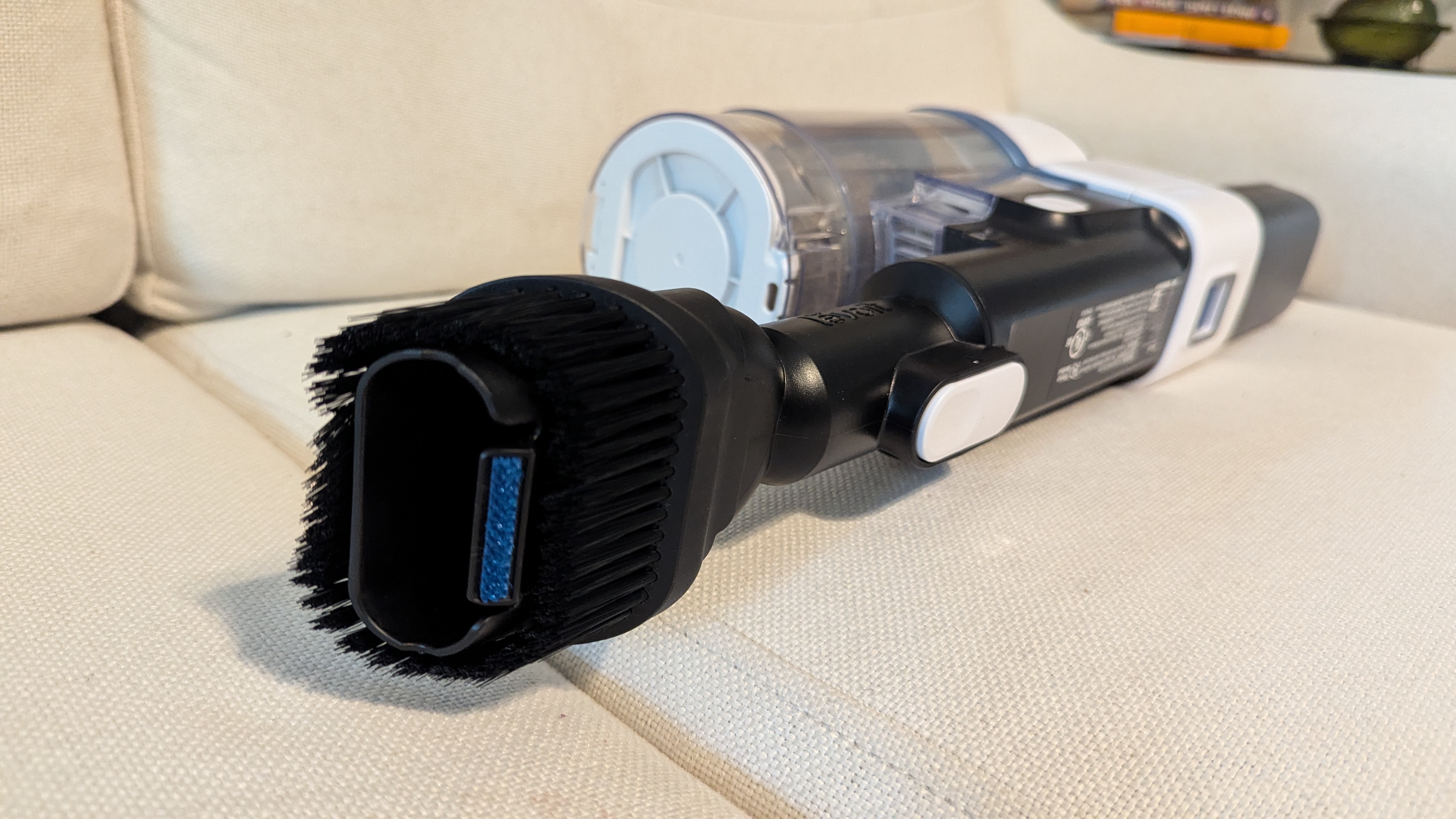 Levoit Aero vacuum in handheld mode lying on a sofa