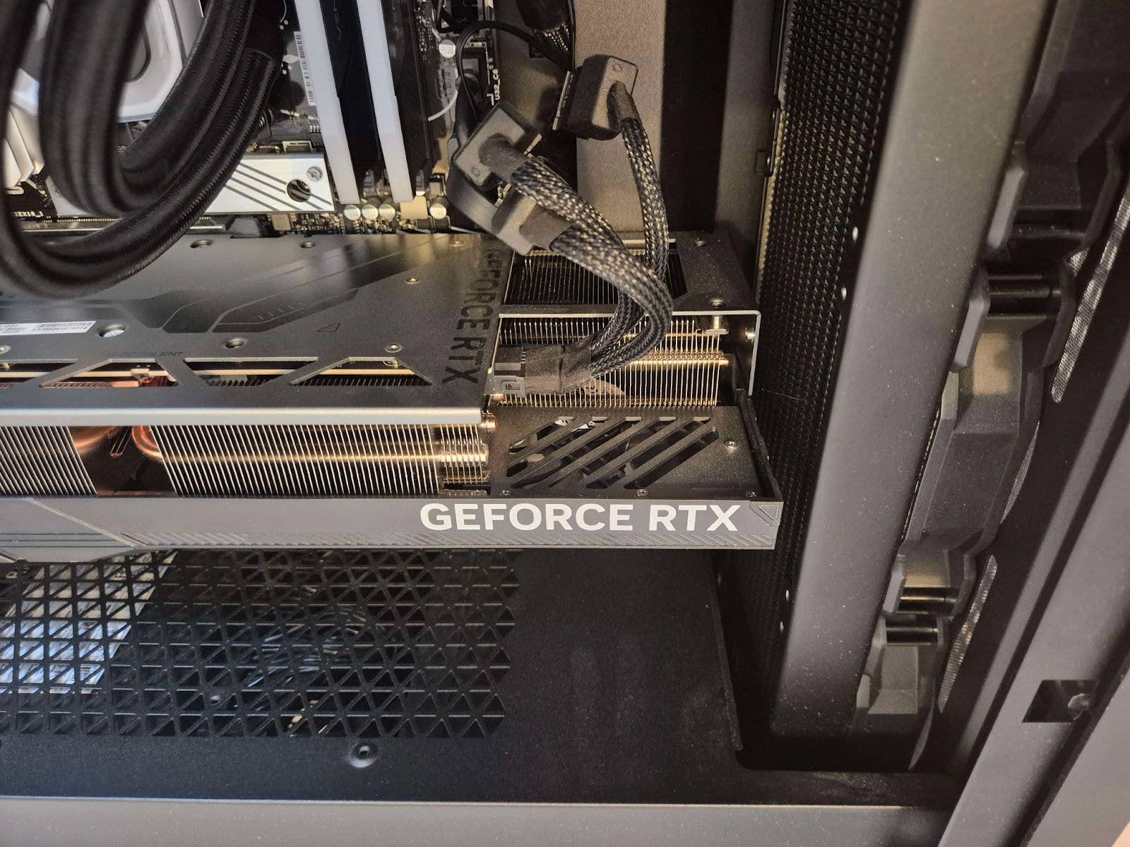 A graphics card in an AMD AM5 motherboard, showing GPU power connectors.