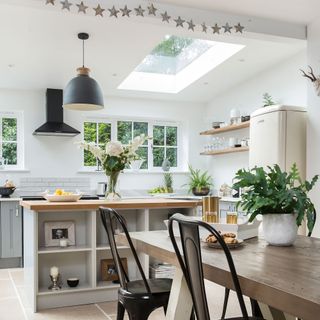 White kitchen-diner with skylight and grey island