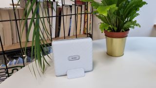 The Fujifilm Instax Link Wide printer on a table, next to a potted plant