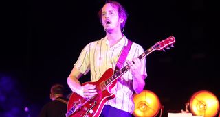 Nick Bockrath of Cage the Elephant plays a red sparkle semi-hollow onstage at Bonnaroo