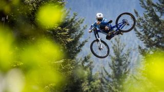 A MTB rider whips the new Kona Process DH over a jump