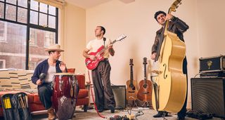 LA LOM [L-R] Nicholas Baker on percussion, Zac Sokolow on his fiberglass guitar, and Jake Faulkner plays a custard-yellow double bass