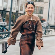 Woman in brown jacket and dress