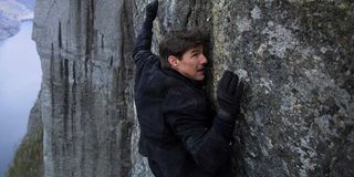 Tom Cruise hangs on for dear life on the side of a cliff in Mission: Impossible - Fallout.