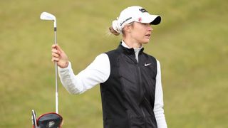 Nelly Korda pulls a club from her bag during a practice round prior to the AIG Women's Open