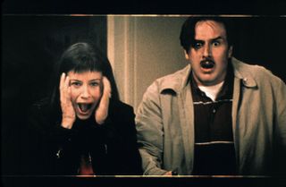 (L to R) Courteney Cox Arquette (as Gale) and David Arquette (as Dewey) screaming in Scream 3