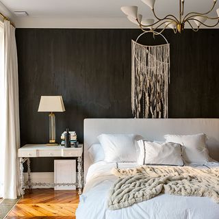 master bedroom with white lamp and white headboard