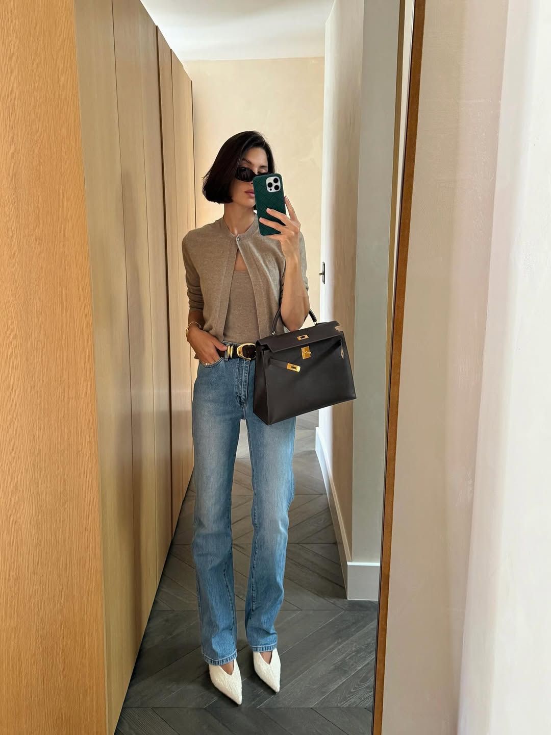 Influencer Jamie Ridge wearing slim jeans, a knitted coord and white pumps.