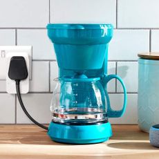 Blue coffee machine on wood counter top connected with Amazon smart plug