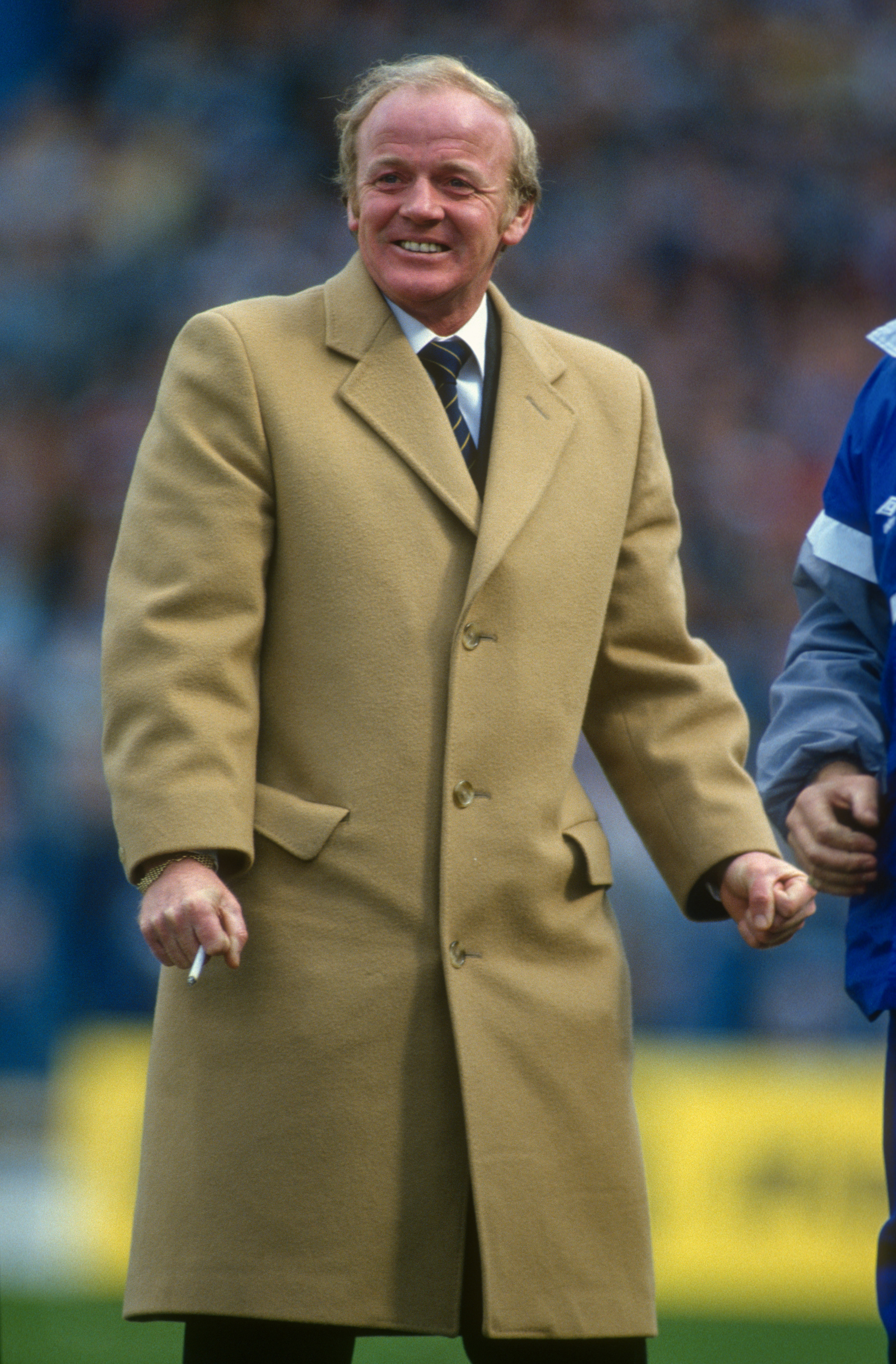 12 April 1987 Sheffield, FA Cup semi-final, Coventry City v Leeds United - Leeds manager Billy Bremner celebrating a goal, while smoking a cigarette and wearing an overcoat. (Photo by Mark Leech/Offside via Getty Images)