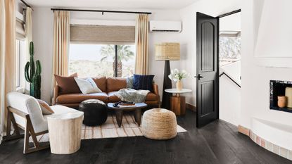 living room with white walls and leather sofa, textured accessories