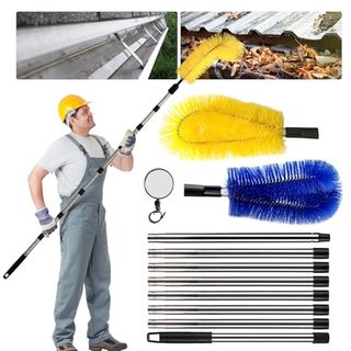 A man in a yellow hard hat holding an extending gutter cleaning brush 