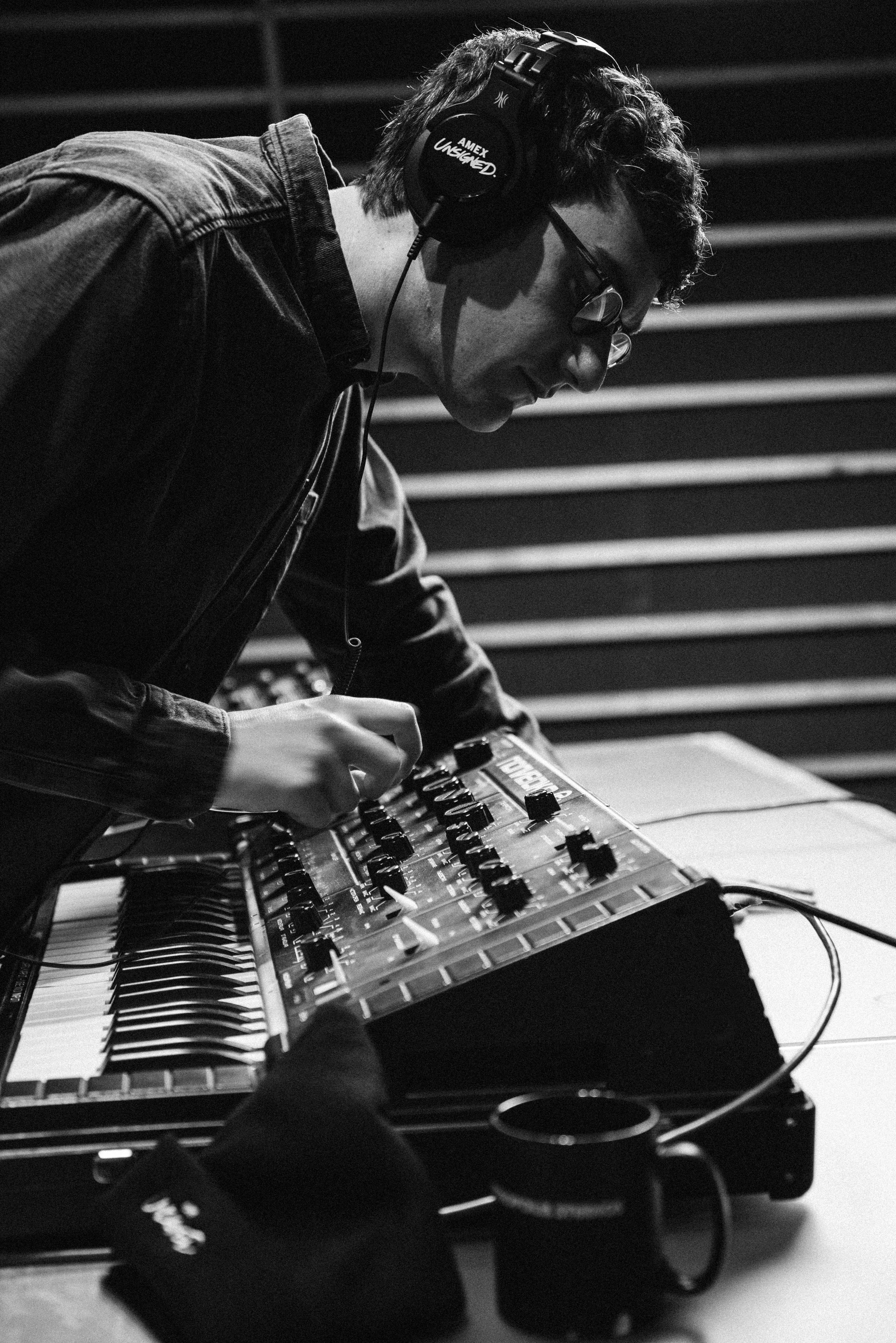 danny l harle in the studio with headphones on