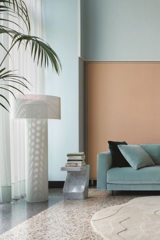 a light blue modern living room with a terracotta accent wall