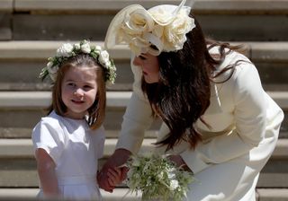 Princess Charlotte of Cambridge stands on the steps with her mother Catherine, Duchess of Cambridge after the wedding of Prince Harry and Ms. Meghan Markle