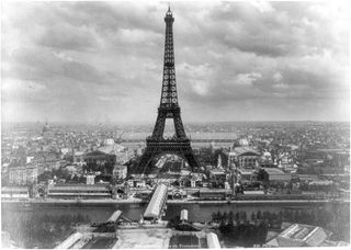 View of the Eiffel tower and the grounds of the Exposition Universelle on the Champs de Mars with Seine and the Pont d'Iena in the foreground, Paris, presumably taken from a tethered balloon above the Trocadero, 1889.