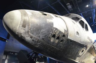 The retired Atlantis orbiter is displayed as if it were in flight at the Kennedy Space Center's new exhibit.