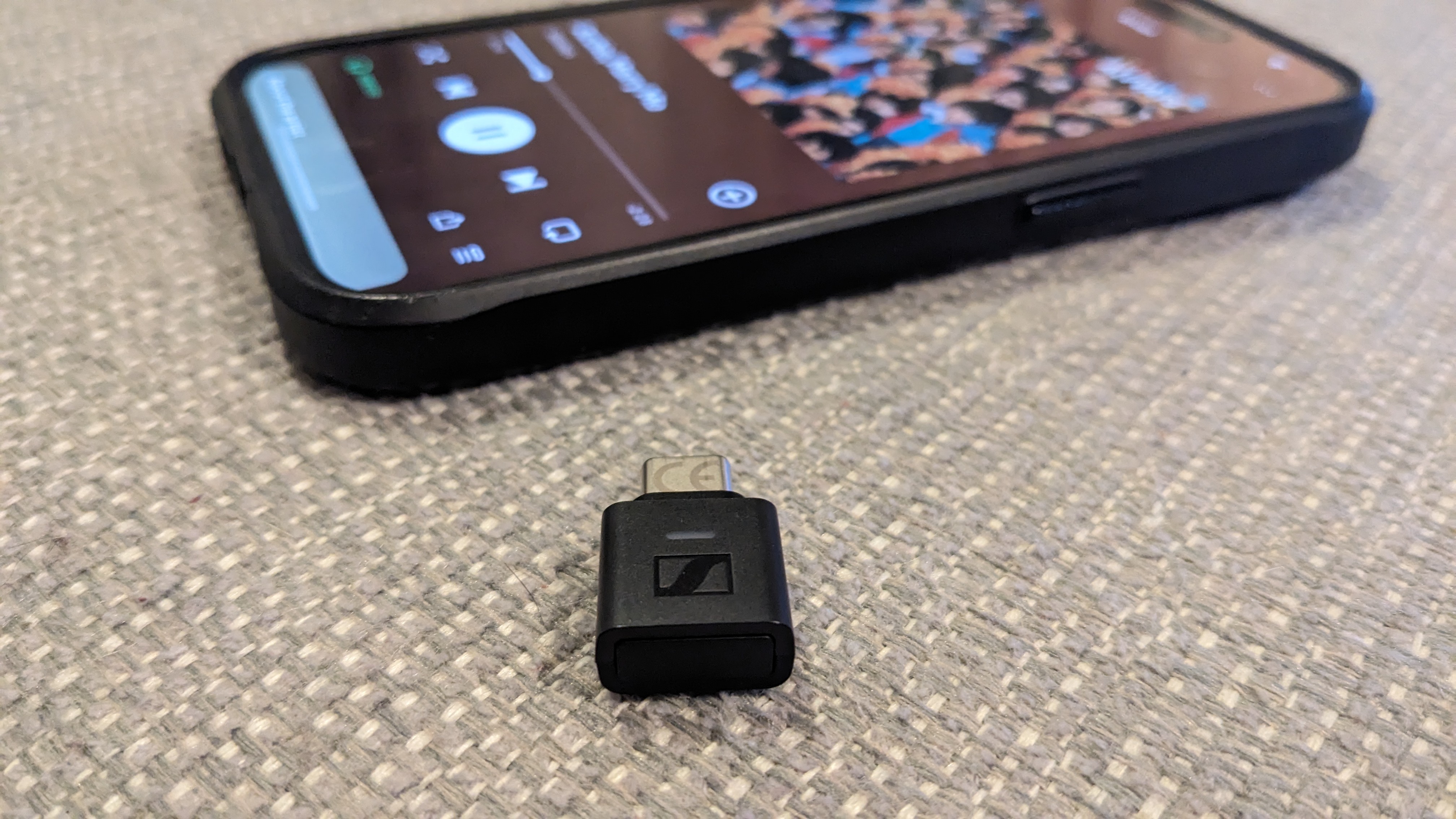 A tiny dongle in front of an iPhone
