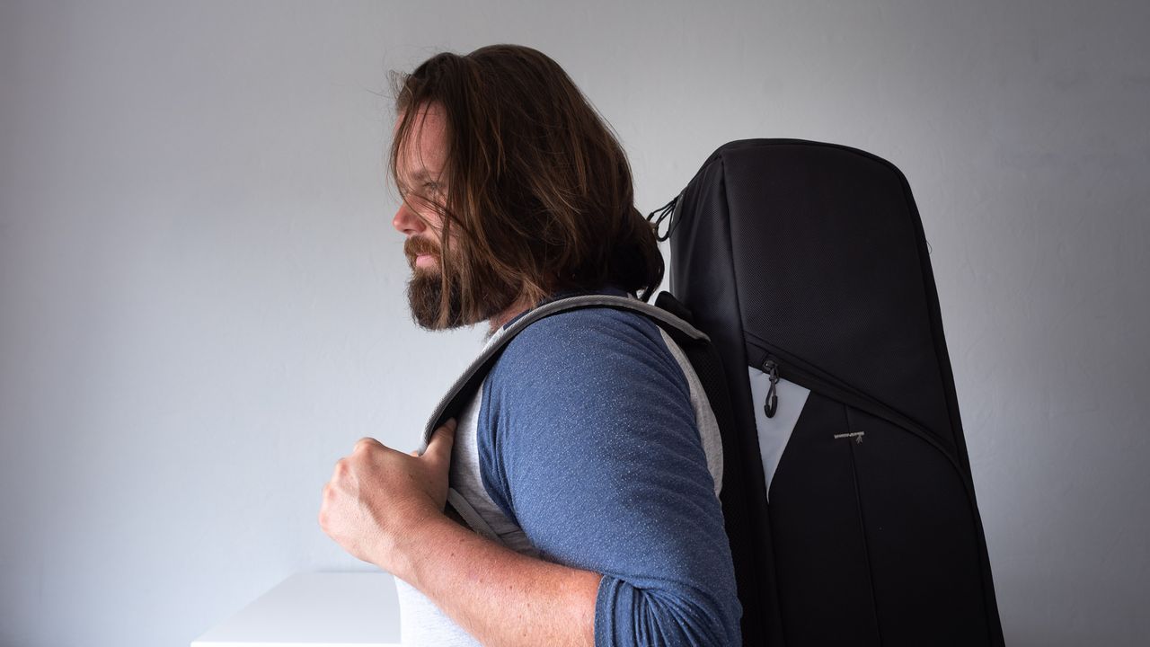 Author carrying backpack with telescope inside
