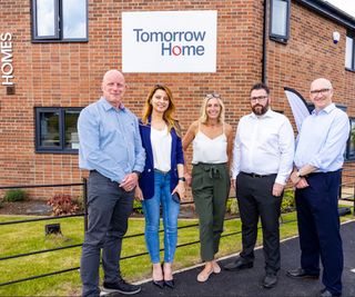 A Lovell demonstration homes with people from Lovell and Teesside University standing in front