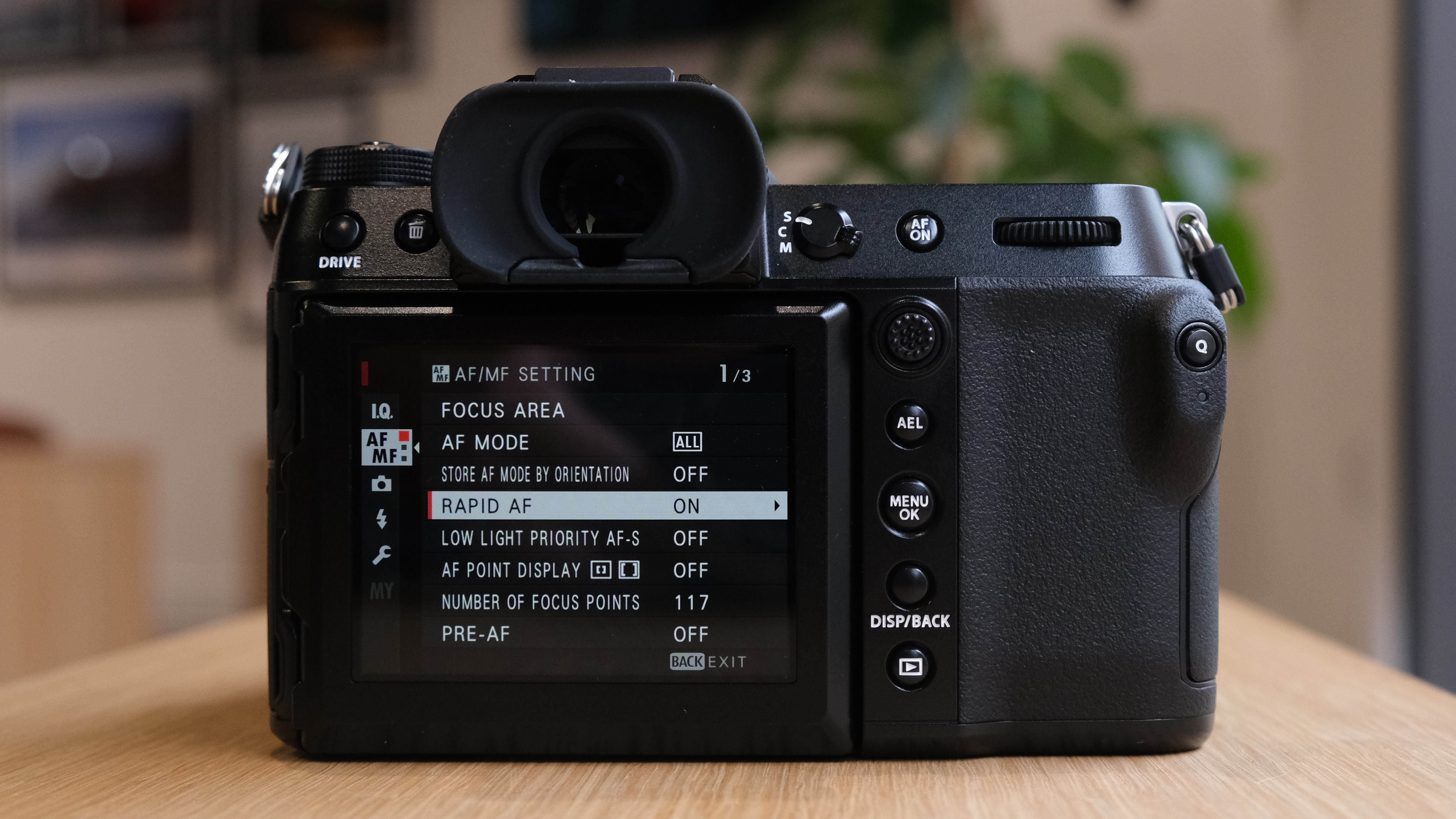 The Fujifilm GFX50S II on a wooden table