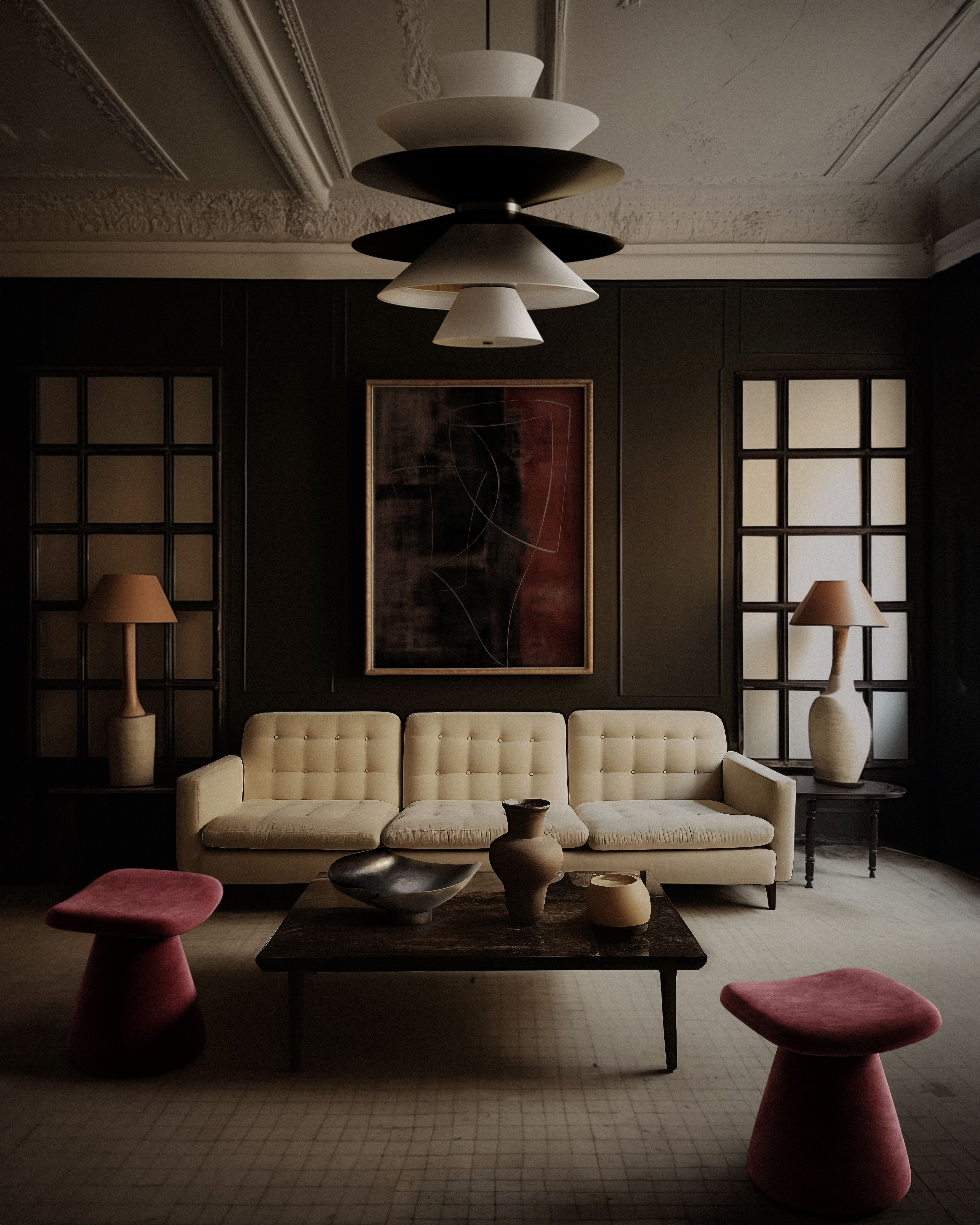 A living room with cream sofa and plum stools