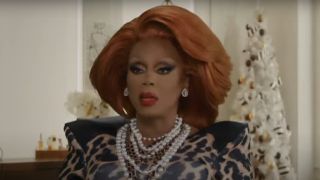 RuPaul with Christmas decorations behind her in The Bitch Who Stole Christmas