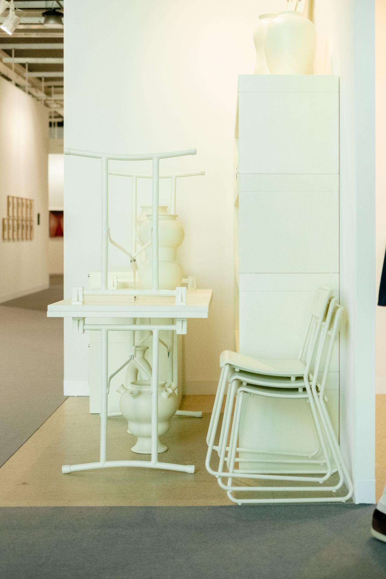 Two furniture-inspired art installations feature beige-tinted home decor with a nostalgic feel.