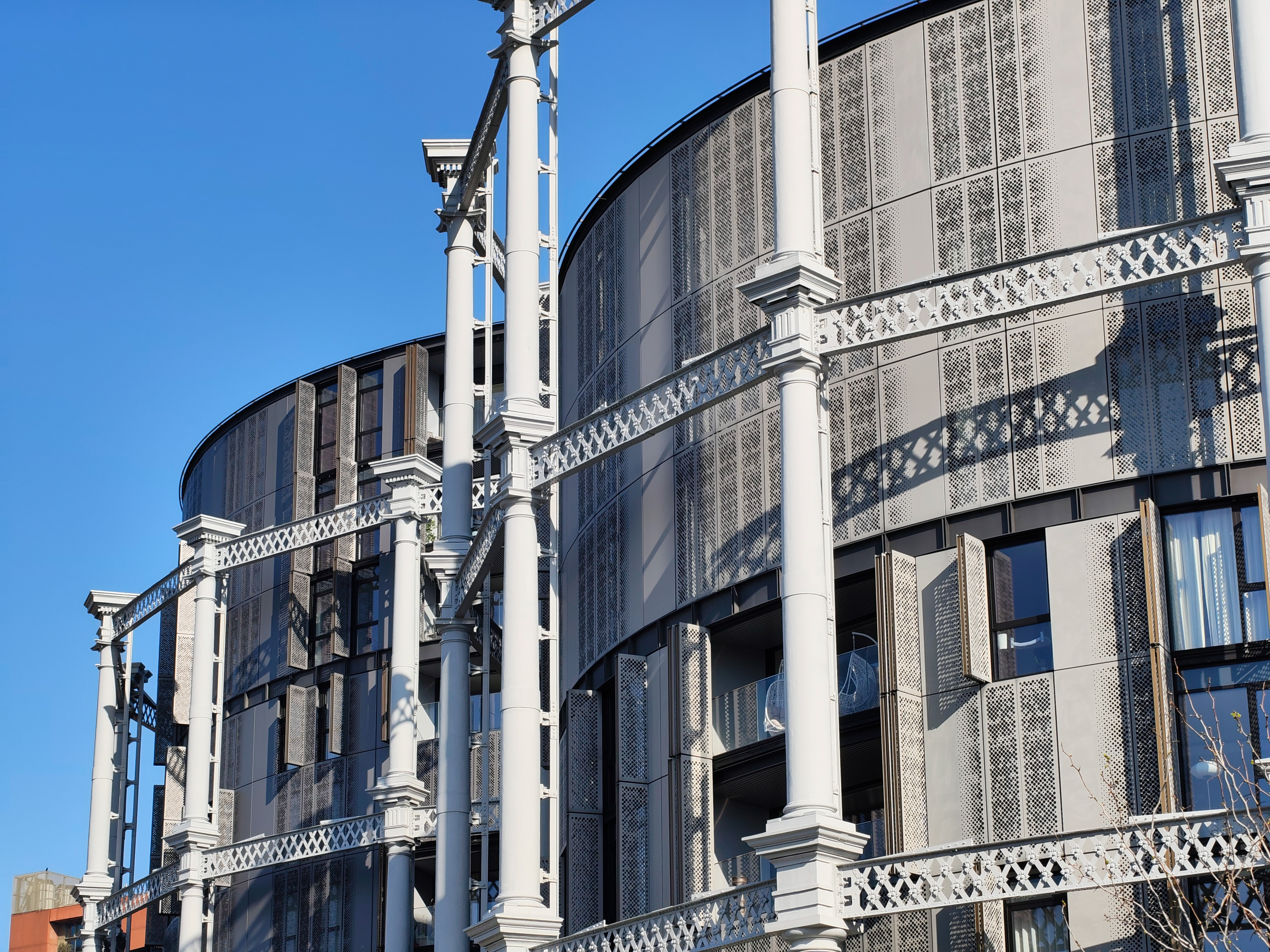 Close-up of the decorative metal columns and latticework of the King&rsquo;s Cross gas holder apartments, photographed with the Nothing Phone (4a).