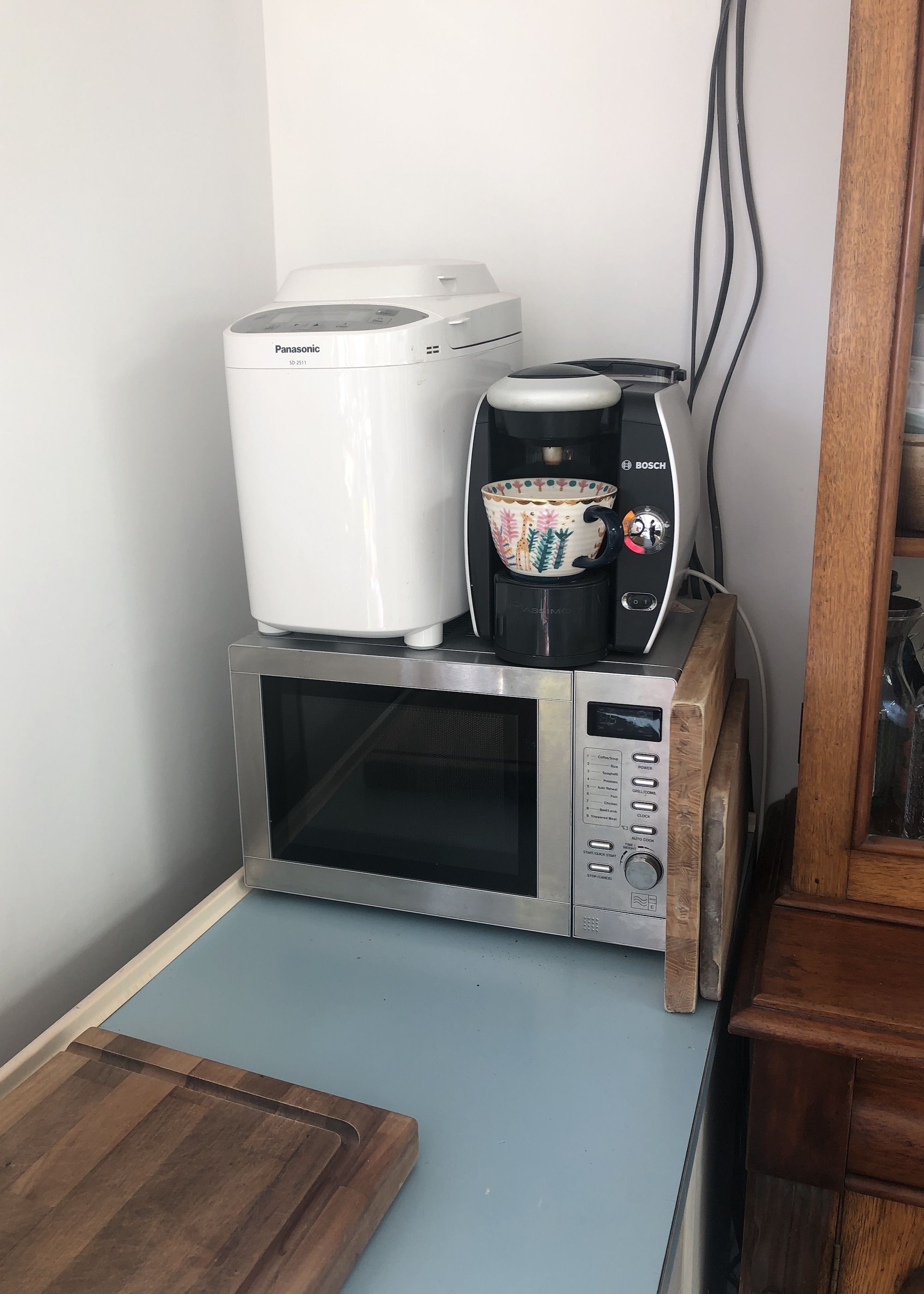microwave with bread maker and coffee machine on top