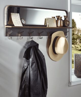 A hallway mirror design with coat hooks