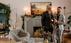 interior designer alykhan velji in front of his christmas fireplace