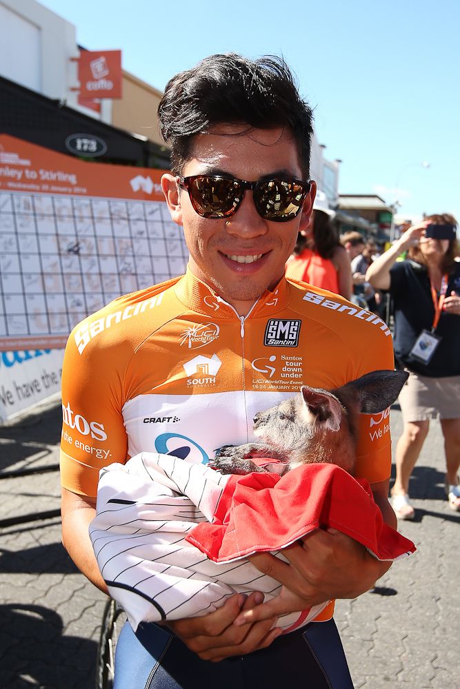 Caleb Ewan holds a joey before the start of stage 2.
