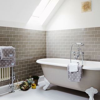 Bathroom with beige bathtub and beige wall tiles